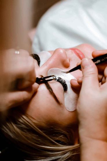 Eyelash extension procedure being applied to a client